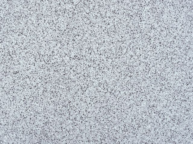 White stone with fine dark speckles