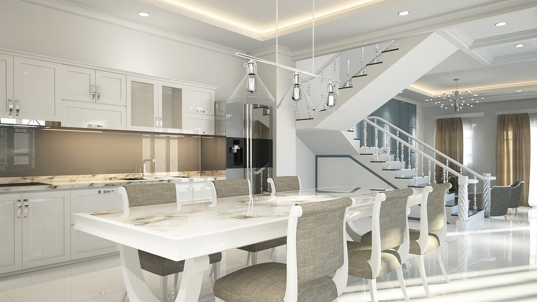 Open kitchen with white stone island and dining area
