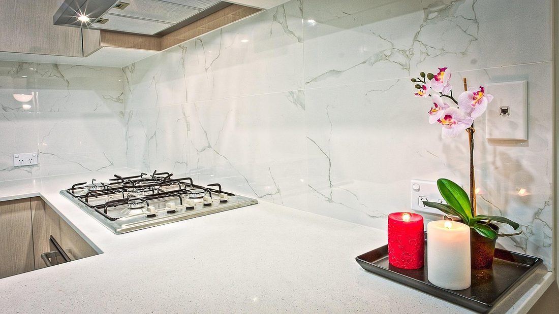 Kitchen with marble-look counters and matching backsplash