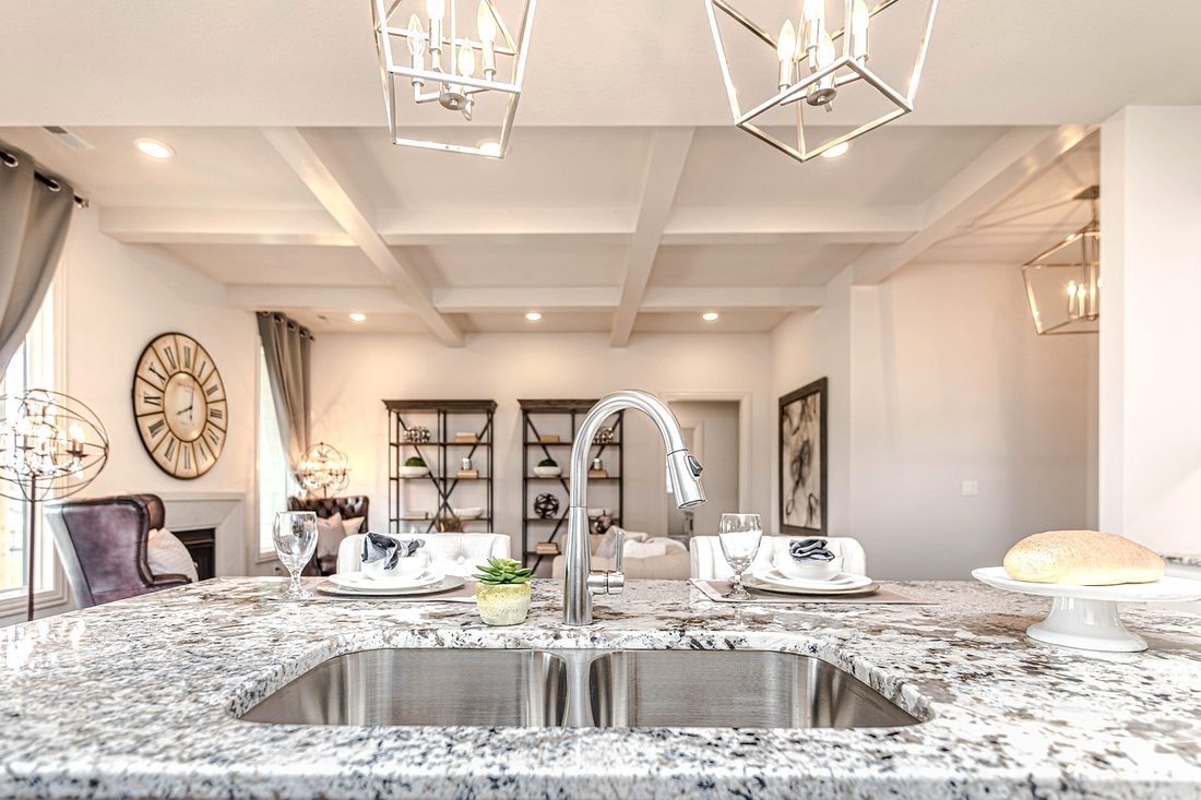 Light speckled granite island with an undermount sink