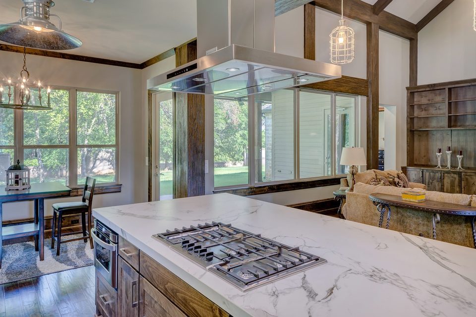 White veined marble island with a gas cooktop