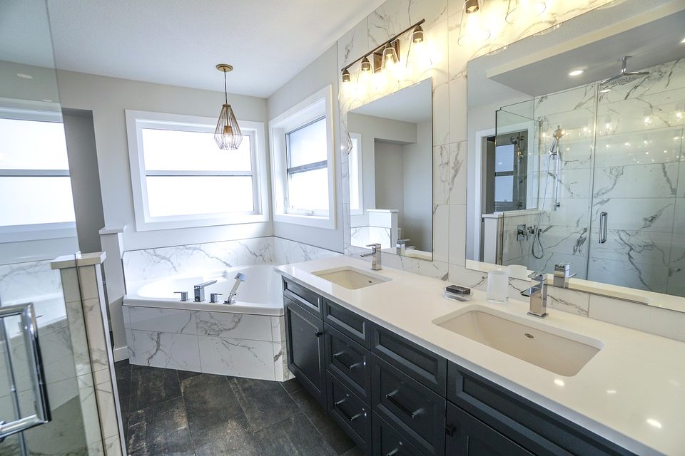 Bright bathroom with a double vanity and stone countertop